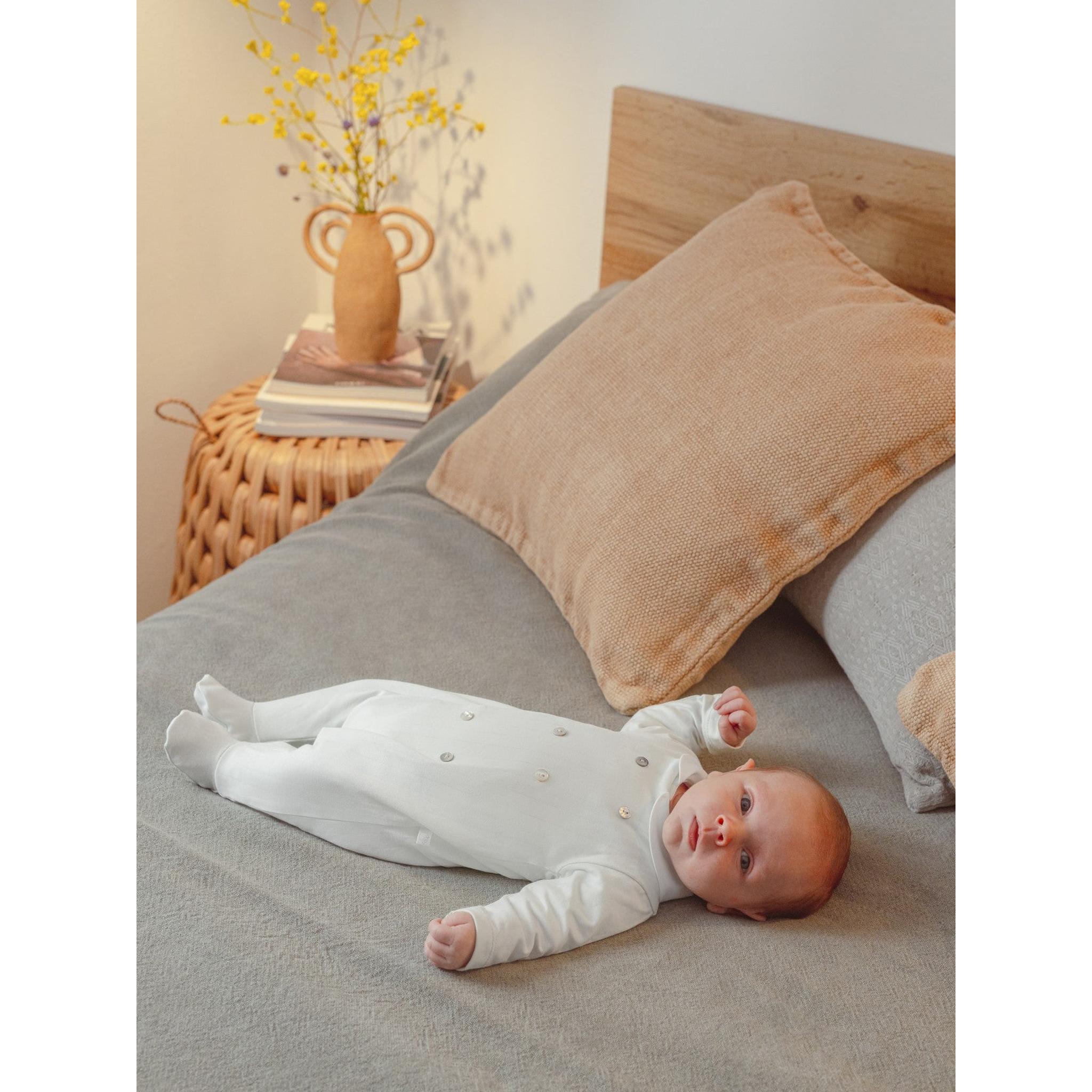 Babygrow embossed stripes with decorative buttons on the front